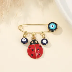Evil eye ladybug brooch metal safety pin fashion jewelry aesthetic accessory fine detail shot