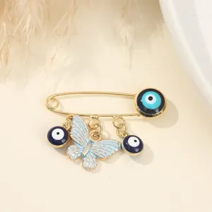 Creative evil eye safety brooch pin featuring a delicate blue butterfly pendant