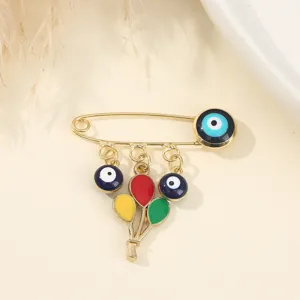 Gold evil eye safety pin brooch featuring colorful balloon charms, sweet fashion jewelry accessory.