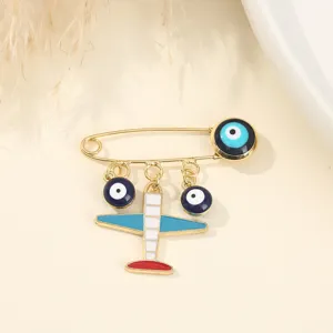 Close-up detail of the creative evil eye airplane brooch, showcasing fine enamel craft.
