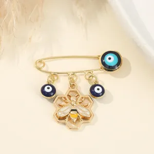 Creative evil eye bee brooch pin, gold-plated alloy honeycomb fashion jewelry accessory.