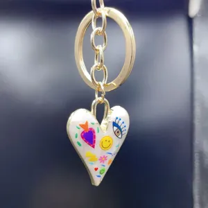 Gold alloy heart keyring with colorful hand-painted eye and flower charms for bags.