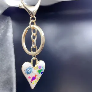 Alloy heart keychain bag charm with colorful doodle enamel pendant detail view for women.