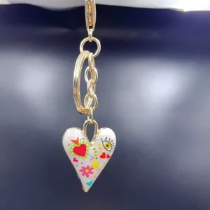 Gold alloy heart keychain with colorful enamel charm, cute bag pendant and keyring accessory.