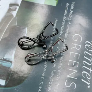 Creative stethoscope brooch detail showcasing gunmetal and silver medical pins for professionals.