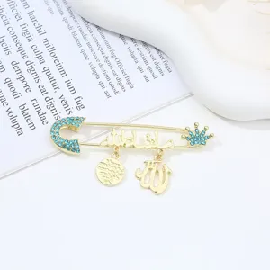 Exquisite gold safety pin brooch with blue rhinestones and Arabic calligraphy pendant.