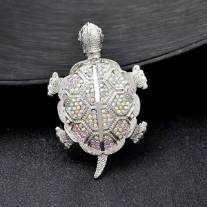 Close-up detail of silver crystal turtle brooch pendant featuring sparkling colorful rhinestones.