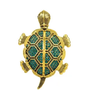 Detailed view of the gold-plated turtle brooch pendant featuring sparkling green crystal rhinestones.