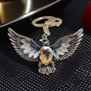Detailed close-up of vintage eagle keychain with sparkling rhinestones and double metal rings.