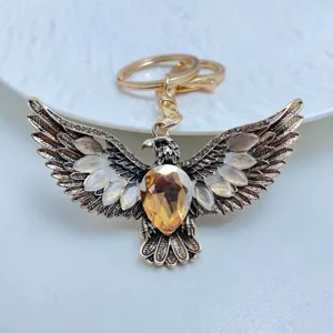 Vintage eagle keychain with cat eye stone and crystal, retro gold metal car key ring accessory.