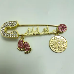 Gold-tone rhinestone safety pin brooch with Arabic calligraphy and pink crystal charms.