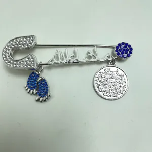 Exquisite silver-tone rhinestone baby brooch with Arabic calligraphy and charms.