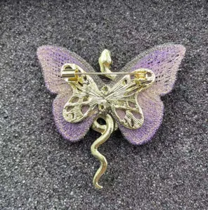 Exquisite gold-plated snake butterfly brooch detailed view with purple fabric embroidery.