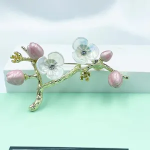Elegant gold-plated flower branch brooch with pink enamel buds and sparkling rhinestone petals.