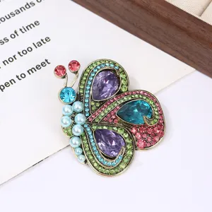 Exquisite detail view of vintage colorful rhinestone butterfly brooch with sparkling crystals.