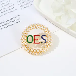 Detailed view of alloy round pearl brooch pin with OES colorful letters for women.