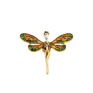 Vintage dragonfly magnetic brooch featuring green and orange enamel and clear crystal.