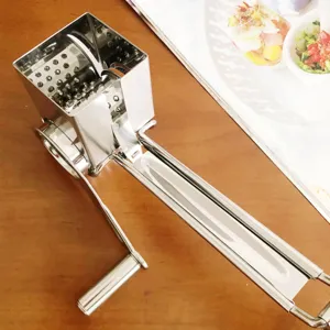 Stainless steel manual rotary cheese grater detail, kitchen tool for grating cheese.