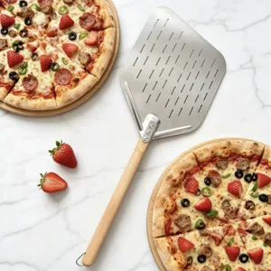 Stainless steel pizza peel detail showing perforated blade, sturdy rivets, and smooth wooden handle.