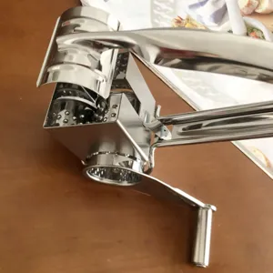 Stainless steel rotary cheese grater manual shredder for kitchen food preparation.