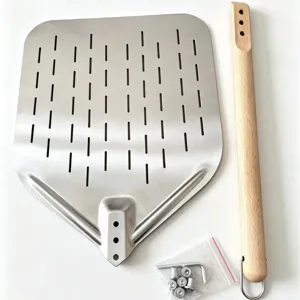 Perforated stainless steel pizza peel with wooden handle for kitchen baking and pizza.
