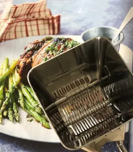Stainless steel manual herb chopper close-up, showing multi-blade rolling mechanism for kitchen prep.