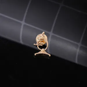 Gold microscope enamel pin detail close up view, scientific lapel badge accessory for clothes.