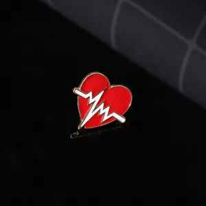 Detail shot of a red heart shaped ecg enamel pin, creative medical style lapel badge jewelry.