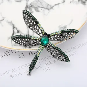 Exquisite dragonfly brooch featuring sparkling green rhinestones and vintage silver alloy.