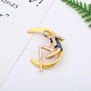 Detailed view of the elegant crescent moon girl brooch, crafted with gold alloy and blue enamel.