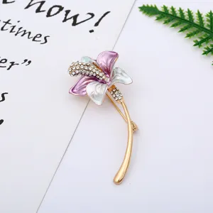 Elegant flower brooch detail, gold-tone metal with colorful enamel and sparkling rhinestones.