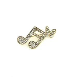 Strass Kristall Musiknote Brosche Nadel, goldfarbenes Metall, elegantes Mode Accessoire Detail.