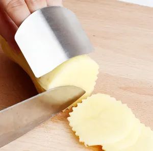 Stainless steel kitchen finger guard detail view protecting hands while slicing vegetables safely.