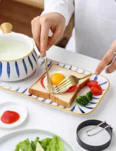 Stainless steel fried egg ring mold tool for easy breakfast cooking and quick shaping.