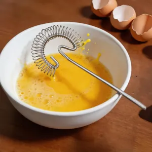 Stainless steel manual spring egg whisk for kitchen baking, egg beating and cream whipping.