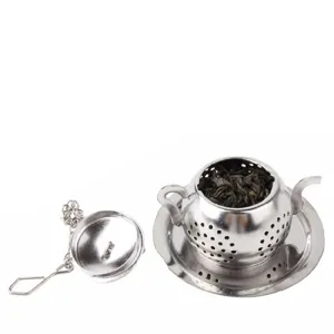 Stainless steel teapot shaped tea infuser with saucer and chain strainer for loose leaf tea.
