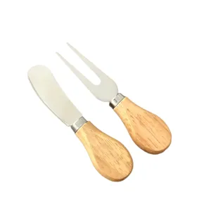 Stainless steel cheese knife and fork set with wooden handles for kitchen table.