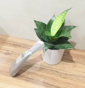 Stainless steel shoe horn detail view, portable metal shoe helper tool for daily home use.