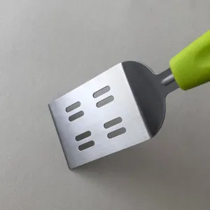 Stainless steel cooking spatula turner with green handle for steak egg pancake teppanyaki.