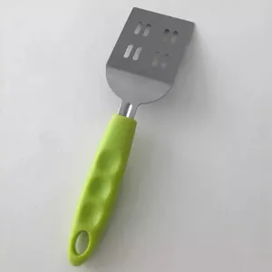 Stainless steel slotted spatula with green handle for cooking steak, eggs, and teppanyaki.