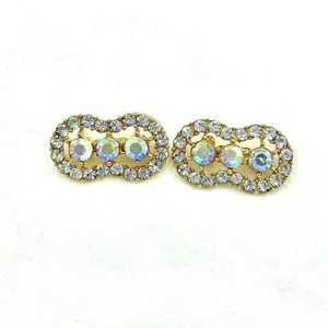 Rhinestone peanut brooch detail shot, alloy crystal lapel pin, elegant scarf buckle accessory.