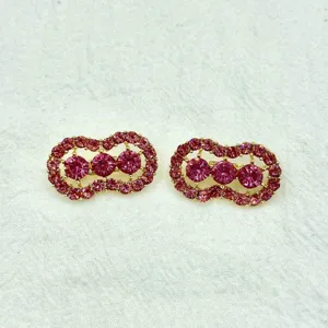 Detailed close-up of shiny pink rhinestone peanut shaped brooch pin for stylish daily wear.
