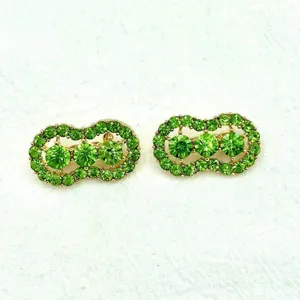 Green rhinestone peanut brooch detail view, elegant alloy crystal pin fashion jewelry.