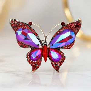 Stunning butterfly rhinestone brooch detail, featuring aurora purple crystal and vibrant red gems.