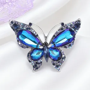 Crystal butterfly brooch detail view, silver tone metal with blue purple rhinestones for women.