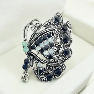 Vintage rhinestone butterfly brooch detail shot, exquisite alloy crystal pin for women suit jacket.