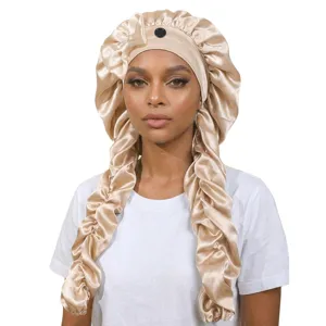 Detailed view of the luxury champagne satin sleep cap with long braided design and cute bow.