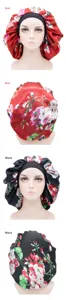 Detailed view of floral satin sleep cap, elastic band, smooth fabric, comfortable hair care bonnet.