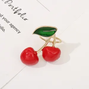 Lindo servilletero de metal de cereza roja y broche para decoración de mesa de fiesta navideña.