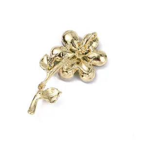 Detailed view of the gold-plated flower brooch back, showing secure pin and clasp mechanism.